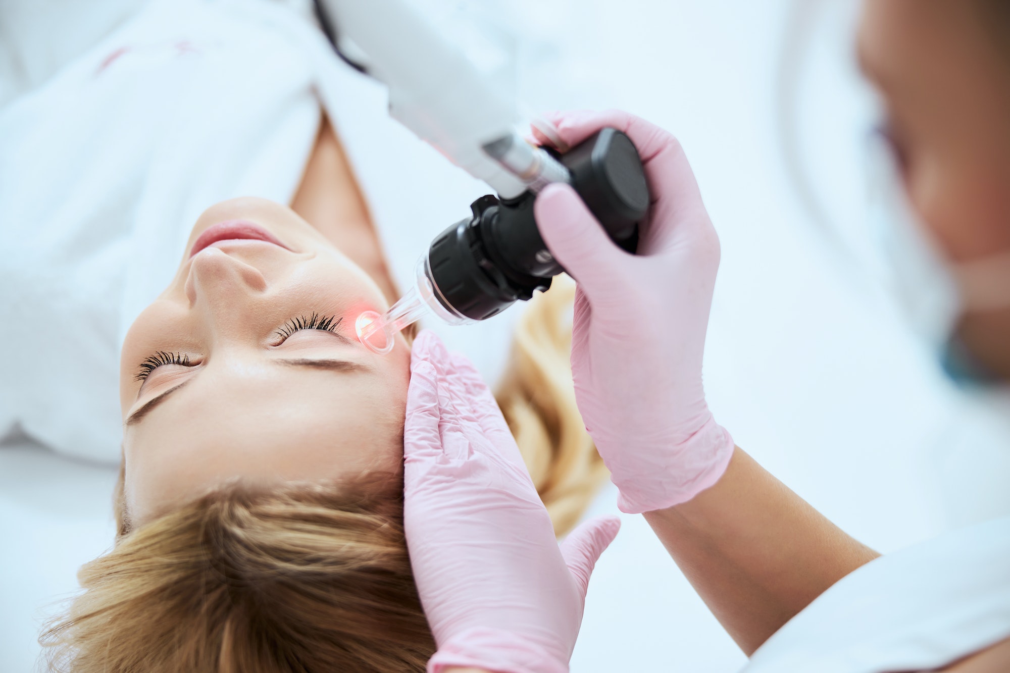 Professional woman dermatologist doing a beauty procedure
